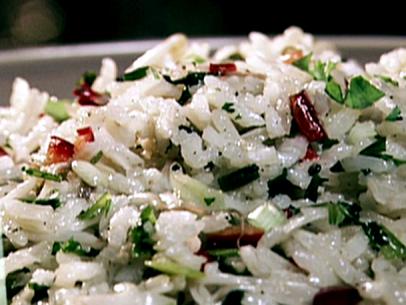 A close up of toasted jasmine rice with grilled scallions. This rice was toasted in peanut oil until it was a light almond color. Chicken stock was added and the rice absorbed the liquid. Scallions were grilled, chopped and added to the rice as well as chopped cilantro, and chopped red jalapenos. Bean sprouts were added at the very end to add an extra crunch.