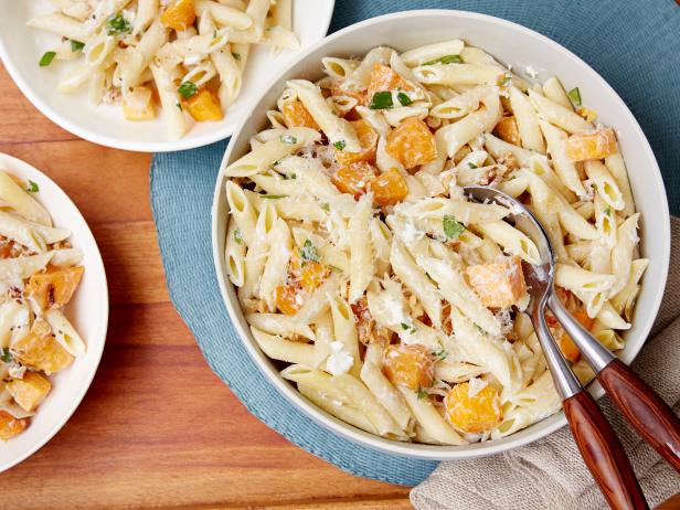 Pasta noodles are tossed with butternut squash, onions and parmesean cheese.