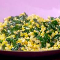 Garlicky creamed corn and spinach is served in a large bowl.