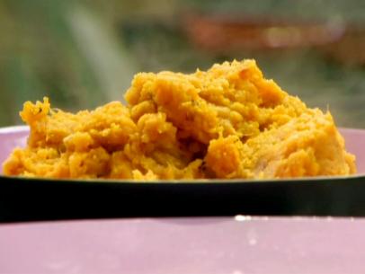 Orange scented mashed sweet potatoes are steaming in a serving bowl.