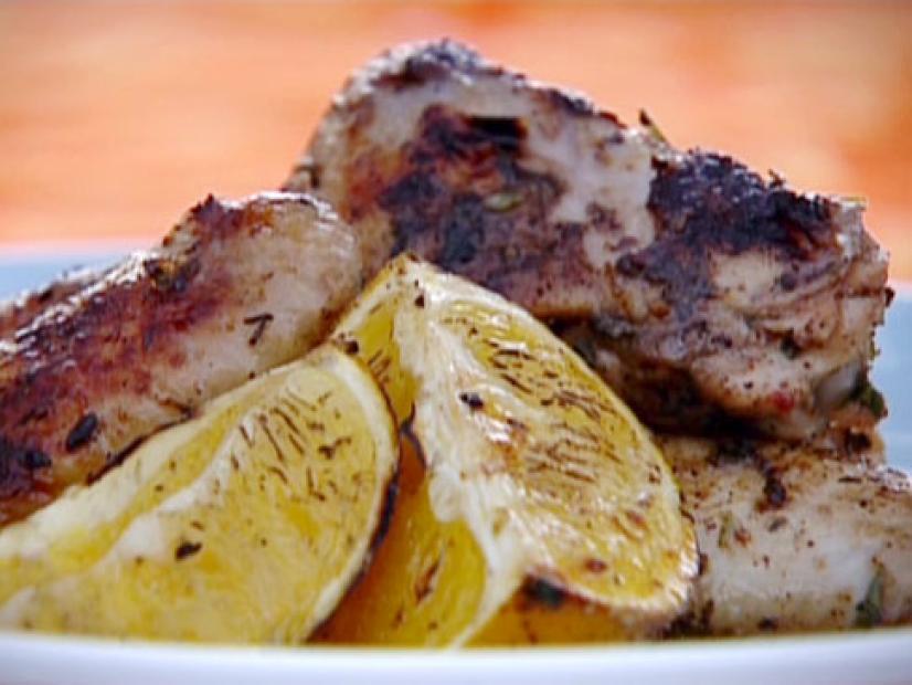 Jerk chicken wings served with wedges of grilled sugared oranges.