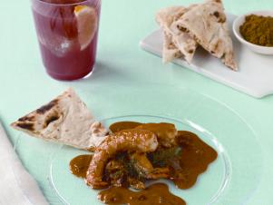 Prawn Masala Served On Clear Plastic Chinet Plate