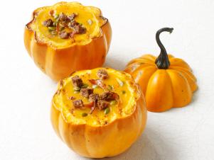 squash soup served in pumpkin bowl for autumn meal