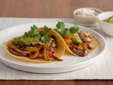 For a south-of-the-border meal, try Food Network Kitchen's Chicken Fajitas recipe, featuring juicy chicken breasts marinated in a cilantro-lime puree.