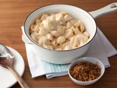 This lighter mac 'n cheese is as deliciously creamy as a traditional version; the perfect texture comes from the evaporated milk, reduced-fat cheddar and Neufchatel cheese. The secret ingredient -- which makes these creamy ingredients go a long way -- is cooked cauliflower blended into the sauce. You don't know it's there, but it adds value to your meal by stretching the sauce while sneaking in a serving of vegetables.