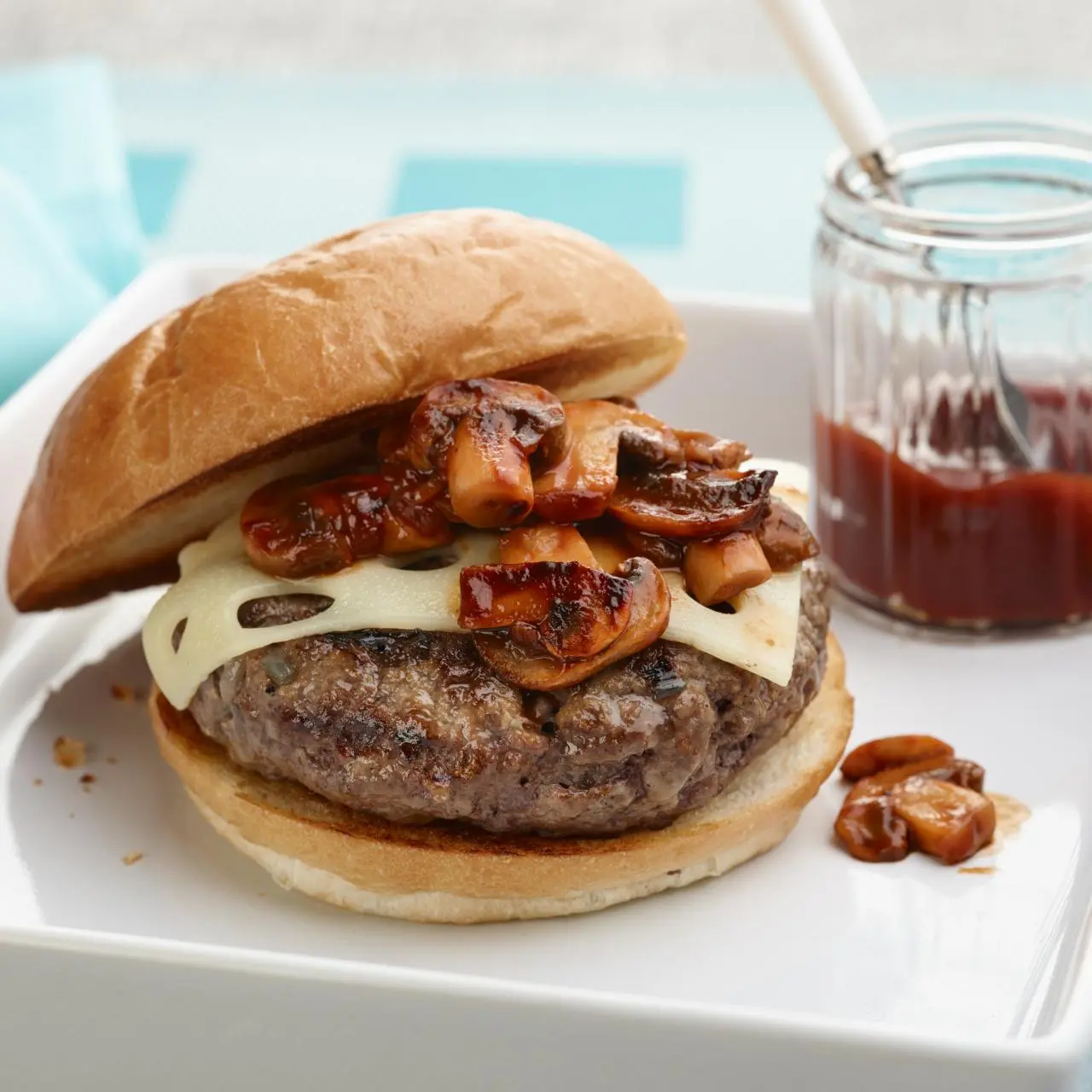 https://food.fnr.sndimg.com/content/dam/images/food/fullset/2011/10/18/0/NY1011_swiss-and-mushroom-bbq-burger_s4x3.jpg.rend.hgtvcom.1280.1280.suffix/1398456681265.webp