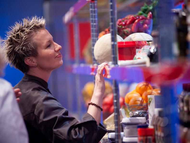 Rival-Chef Elizabeth Falkner looking through pantries in Episode 1 as seen on Food Network Next Iron Chef Season 4.