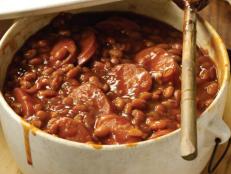 Pat: Every Fourth of July, Mama Neely made her famous baked beans: she'd brown ground beef and then doctor that beef with molasses, brown sugar, and plenty of spices. Let me tell you, those beans were good. And so are these. We've found that using smoked sausage in place of the ground beef (or pork shoulder, as in our restaurant recipe) adds a smoky depth to the dish. Once you make these beans, there is no going back. If you want to put your own spin on it, you can use kidney beans instead of pork and beans, but I say my mama's way is best.