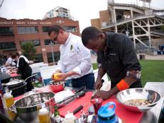 Rival-Chef Robert Irvine and Rival-Chef Marcus Samuelsson cooking for the Chairman's Challenge "Stadium Food" in Episode 2 as seen on Food Network Next Iron Chef Season 4.