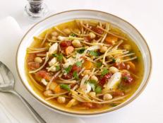 Add some protein power to your chicken noodle soup with the addition of chickpeas. Cilantro and tomatoes add color and zest.