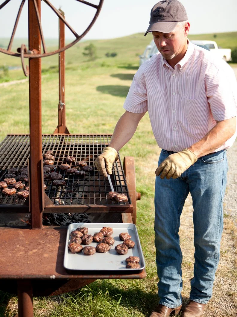 Ree Drummond - host, helps her husband Ladd Drummond as he prepares to grill Sliders for his son Todd's birthday party during episode 3 as seen on Food Network's Pioneer Woman Season 1. 