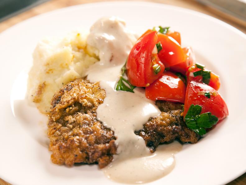 Ree Drummond - Host prepares mashed potatoes, chicken fried steak and marinated tomato salad during episode 1 as seen on Food Network's Pioneer Woman Season 1. 