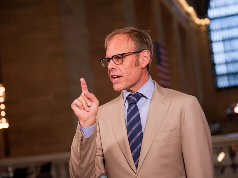 Host Alton Brown looking over Rival-Chef's final dishes for Episode 5 Chairman's Challenge "Story Telling" as seen on Food Network Next Iron Chef Season 4.