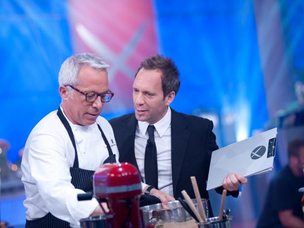 Floor Reporter Kevin Brauch checking in with Rival-Chef Geoffrey Zakarian during his head-to-head battle against Rival-Chef Elizabeth Falkner in Episode 8 Finale Battle "Holiday Extravaganza" as seen on Food Network Next Iron Chef Season 4.