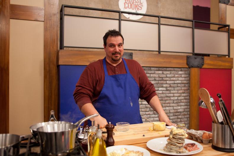 Worst Cooks In America  Blue Team Recruit Vinnie Caligiuri prepares Blue Corn Pancakes with Whipped Orange Honey Butter, Cinnamon Maple Syrup and Canadian Bacon for the "Back to Basics Breakfast"  challenge as Chefs watch as seen on Food Network's Worst Cooks in America, Season 3.