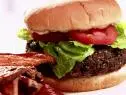 A black bean burger is served with lettuce and tomato.