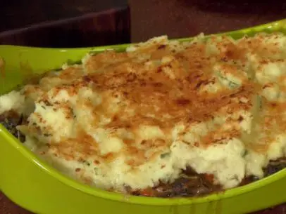 Meatless shepherd's pie made with mushrooms, carrots, garlic, kale, onions, rosemary, and potatoes on top