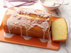 For the perfect tea cake, bake Ina Garten's Lemon Yogurt Cake recipe, finished with a sweet lemon glaze, from Barefoot Contessa on Food Network.