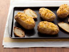 For a special dinner side, load these Twice-Baked Potatoes from Food Network Kitchen with butter, sour cream and cheese.