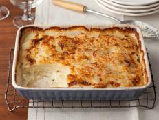 For a rich and creamy side, try Tyler Florence's ultimate Scalloped Potato Gratin recipe from Food Network.