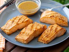 Ina Garten's Asian Grilled Salmon, from Barefoot Contessa on Food Network, is a light, quick main dish with salty-sharp flavors like Dijon and soy sauce.