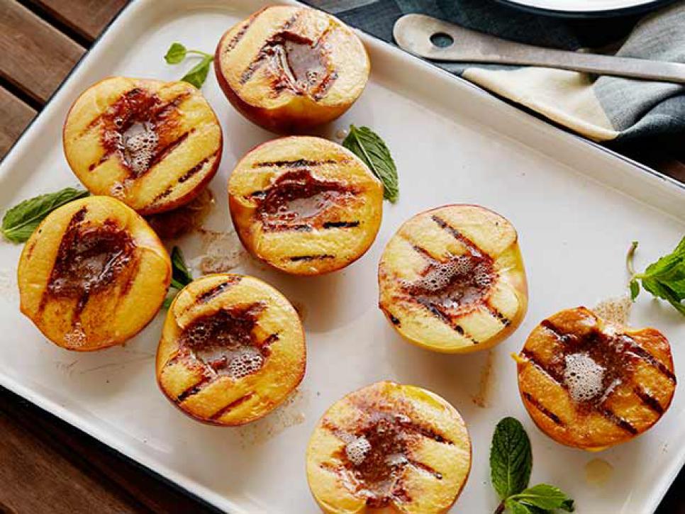 Bobby puts his peaches cut-side-down on the grill for a few minutes for a sweet-and-smoky dessert that you’re sure to be making all summer long.