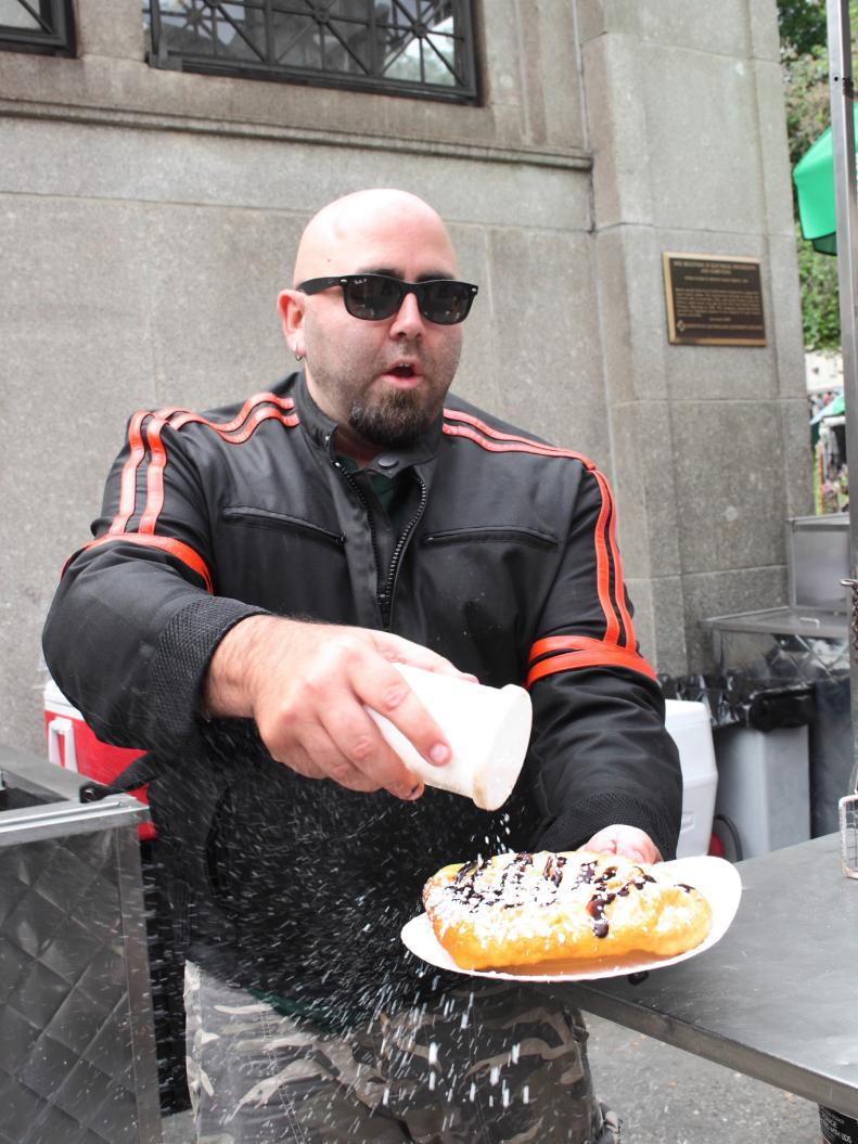 Duff Goldman at Daddy's Fried Dough stand in the Boston Common, learning how to make Boston Cream Fried Dough, as well as how to meet and greet the street customers, as seen on Food Network's Sugar High, season 1.