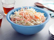 Spiked with vinegar and spiced with mustard, Bobby Flay's Creamy Coleslaw recipe is the perfect picnic side from Boy Meets Grill on Food Network.