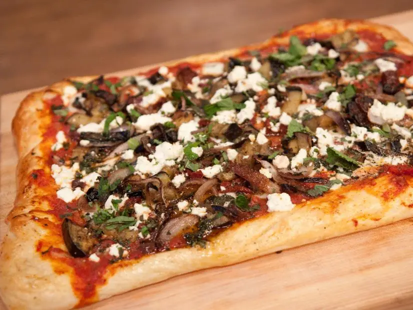 FNS7 Episode 2 Finalist Penny Davidi's "Middle Eastern Pizza" Beauty for Camera Challenge.  Ingredients:  Roasted Eggplant, caramalized onions, feta, cumin, garlic, mint, calamata olives, sumac infused tomato sauce, sun-dried tomatoes and buffalo mozzarella.