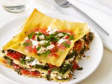 Today is National Lasagna Day: a day when flat noodles, cheese and tomatoes meld into one heavenly stacked and saucy dish. Food Network recipes feature the best lasagna has to offer.