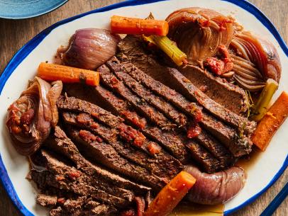 Description: Tyler Florence's Beef Brisket. Keywords: Garlic, Rosemary, Beef Brisket, Carrots, Celery, Red Onions, Dry Red Wine, Russet Potatoes, Onions, Eggs, Chives.