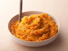 Banana and orange add layers of flavor to Rachael Ray's Mashed Sweet Potatoes, from 30 Minute Meals on Food Network.