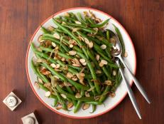 Tyler Florence's Green Beans with Caramelized Onions and Almonds recipe for Food Network is a holiday meal essential.