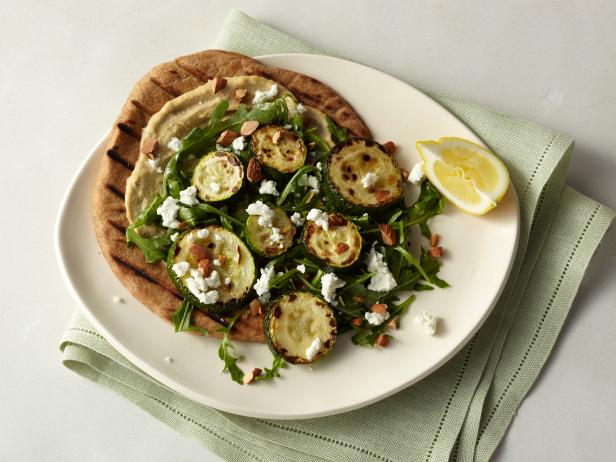 Picture of Roasted Zucchini Flatbread with Hummus, Arugula, Goat Cheese, and Almonds Recipe