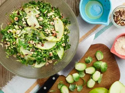 Chef Name: Guy Fieri 

Full Recipe Name: Shaved Brussels Sprout and Kale Slaw with Pecorino and Toasted Hazelnuts

Talent Recipe: Guy Fieri's Shaved Brussels Sprout and Kale Slaw with Pecorino and Toasted Hazelnuts, as seen on Guy's Big Bite.

FNK Recipe: 

Project: Foodnetwork.com, Back to School/Sandwich Central/Dinner and a Movie/Sides

Show Name: Guy's Big Bite

Food Network / Cooking Channel: Food Network