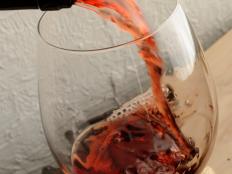 Pouring a glass of red wine.