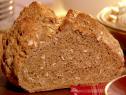 A loaf of soda bread with oats sitting on a counter