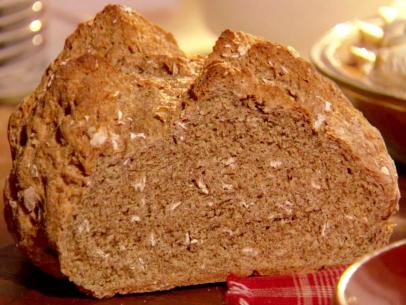 A loaf of soda bread with oats sitting on a counter