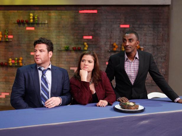 (L-R) Special Guest Judges Scott Conant, Alex Guarnaschelli, and Marcus Samuelsson from "Chopped," watch Cheech Marin from Guy Fieri's team (not shown) and Summer Sanders from Host Rachael Ray's team (not shown) prepare a steak of the third challenge in the 1-on-1 Battles as seen on Episode 3 of Food Network's Rachael Vs. Guy Season 1