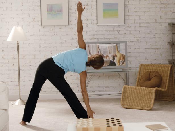 Woman doing yoga to exercise video