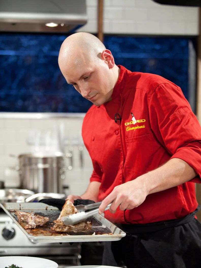 Chef Sean Scotese plates his dish, as seen on Food Network’s Chopped Champions, Season 14.
