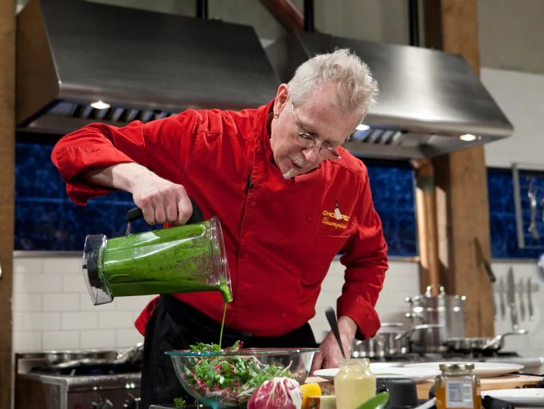 Chopped Champion Chef Kenneth Johnson working on his appetizer which must include: pig ears, ramps, pine nuts and apple strudel, as seen on Food Networks Chopped, Season 14.