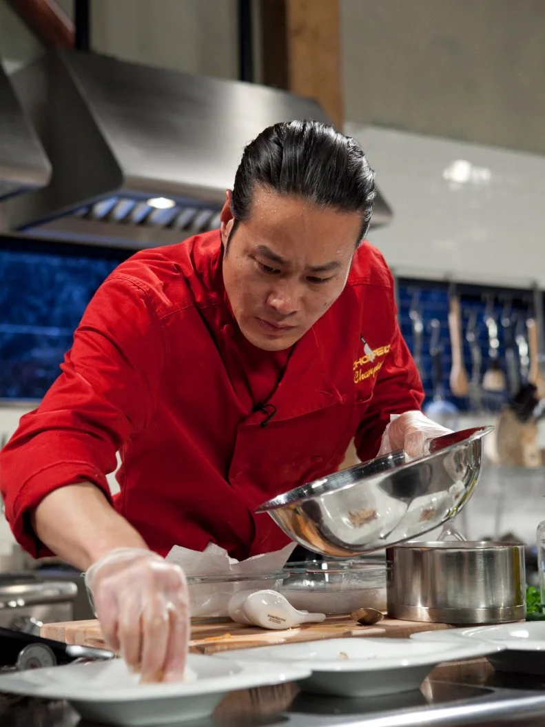Chopped Champion Chef Jun Tanaka working on his entree that must include: Abalone, curry leaves, amaranth grain, Serrano Ham, as seen on Food Networks Chopped, Season 14.