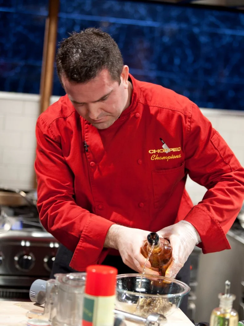 Chef Sylvain Harribey makes a sauce, as seen on Food Network’s Chopped Champions, Season 14.
