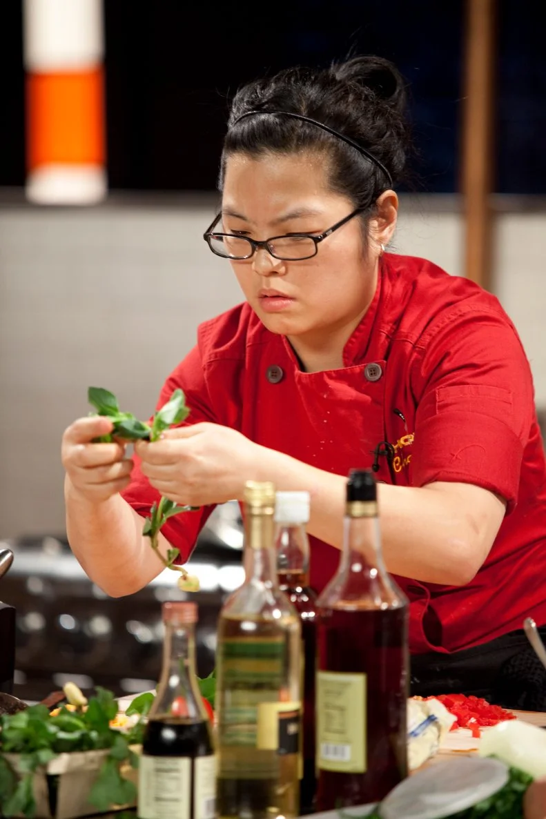 Chef Hellen Park works with greens, as seen on Food Network’s Chopped Champions, Season 14.
