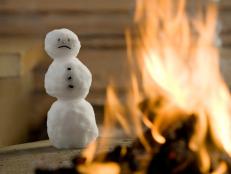 Snowman next to a fire