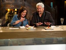 Host/Team Leaders Rachael Ray and Guy Fieri blind-tasting the dishes, as seen on Food Network’s Rachael vs. Guy: Celebrity Cook-Off, Season 2. 

