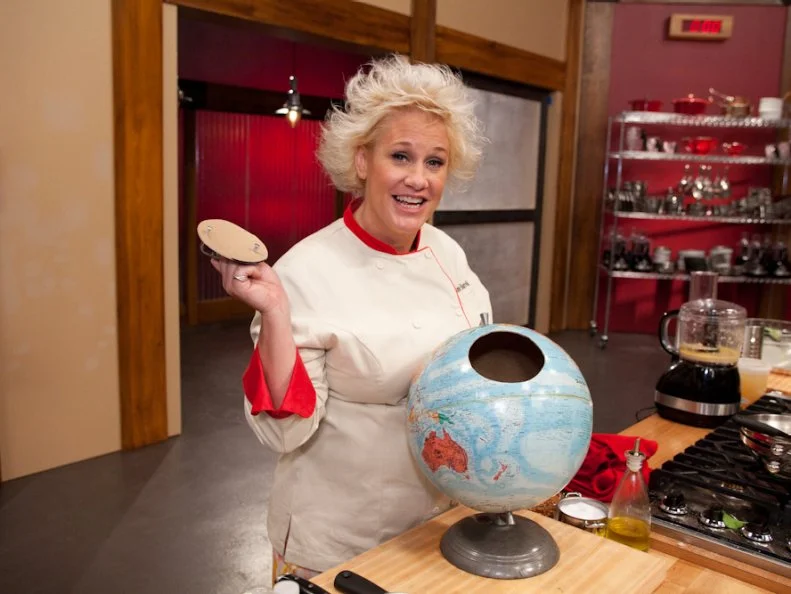 Red Team Leader Chef Anne Burrell with globe used to pick recipes for the "International Meatballs" challenge as seen on Food Network's Worst Cooks in America, Season 3.