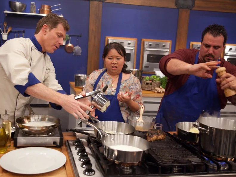 Chef Bobby Flay checks in with Blue Team Recruit  Sarina Weeraprajuk as she prepares her "Asian Sensation" steak for the Extreme Flavor Challenge" as seen on Food Network's Worst Cooks in America, Season 3.