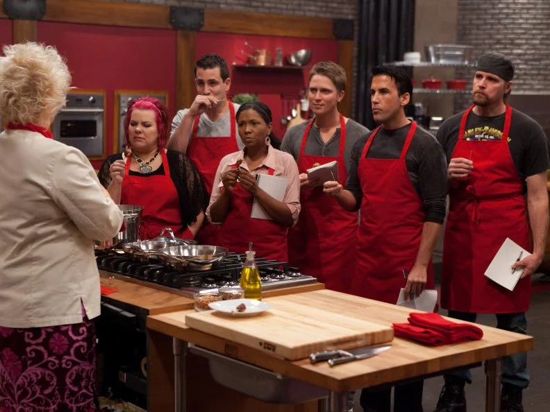 RedTeam Leader Chef Anne Burrell gives Recruit Kelli Powers a taste to identify as recruits look on in the "Extreme Flavor Challenge" as seen on Food Network's Worst Cooks in America, Season 3.